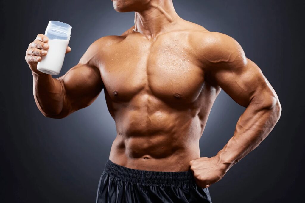 Muscular male athlete holding a shaker bottle with defined arms and chest, representing strength training, muscle growth, and performance enhancement associated with buying Ultima-MYO 1mg from OSGear.to.